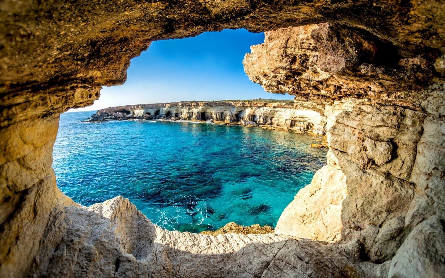 An awe-inspiring image of Cape Greco in Cyprus, showcasing its rugged coastline and clear waters. With natural sea caves, beautiful beaches, scenic hiking trails, and stunning views of the Mediterranean Sea, it's a must-visit for those seeking things to do in Cyprus.