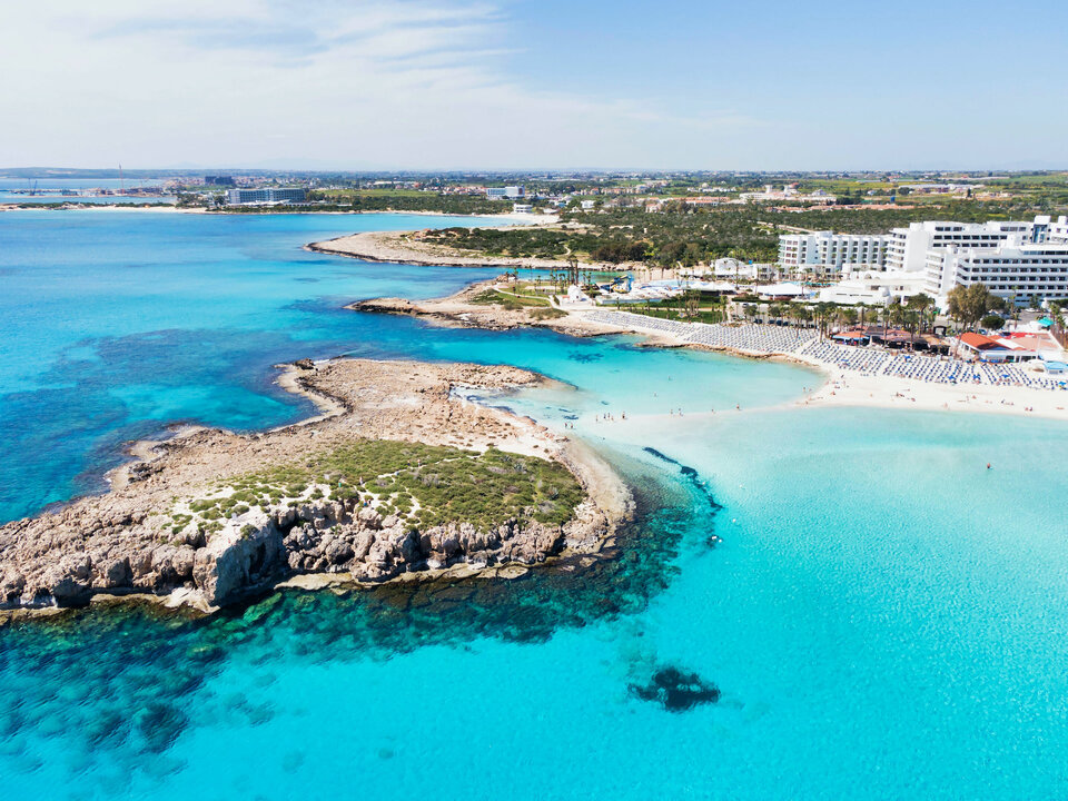 Crystal clear turquoise waters and golden sand beach at Nissi beach, Ayia Napa - one of the best things to do in Cyprus.