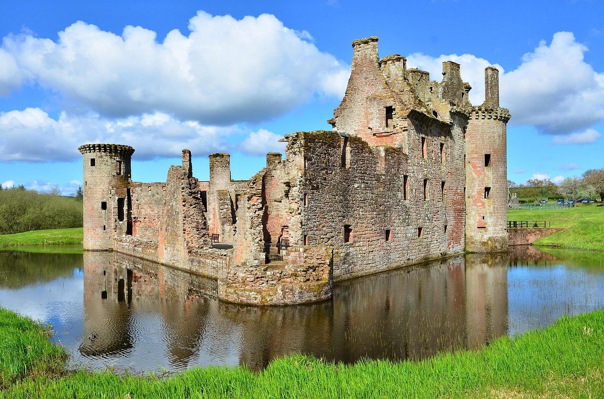 A photo of Caerlaverock Castle, a well-preserved medieval fortress in Dumfries, Scotland, with its walls and towers visible